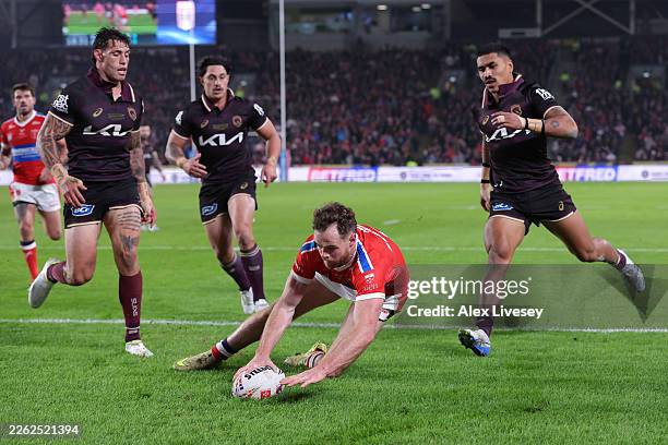 Joe Burgess of Hull KR dives over the line to score their third try during the World Club Challenge match between Hull KR and Brisbane Broncosat at...