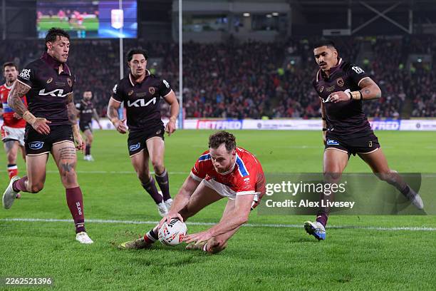 Joe Burgess of Hull KR dives over the line to score their third try during the World Club Challenge match between Hull KR and Brisbane Broncosat at...