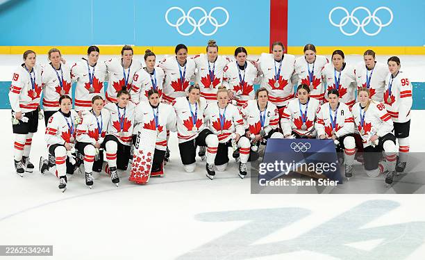 Silver medalist Team Canada pose for photographs after the medal ceremony for the Ice Hockey Women following during the Women's Gold Medal match...