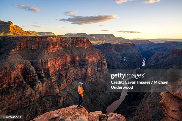 active blonde hiker at tuweep overlook sunset - golden hour stock pictures, royalty-free photos & images