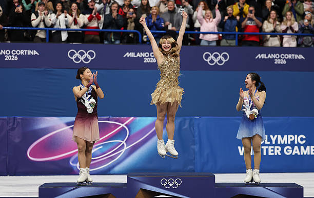 Gold medalist Alysa Liu of Team United States, silver medalist Kaori Sakamoto of Team Japan and bronze medalist Ami Nakai of Team Japan on the podium...
