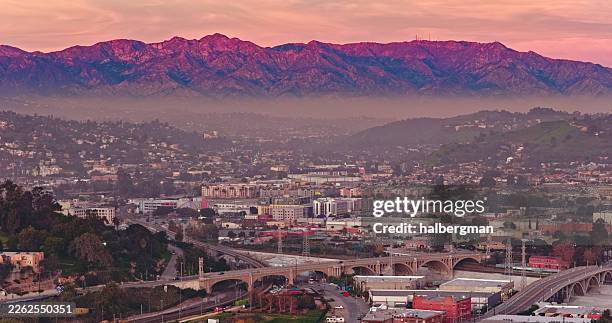aerial view of downtown los angeles at sunset with san gabriel mountains - foothills stock pictures, royalty-free photos & images