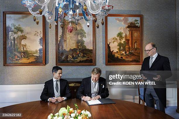 Netherlands' King Willem-Alexander next to Prime Minister Rob Jetten takes part in the signing of the Royal Decrees in the Meeting Room at Huis ten...
