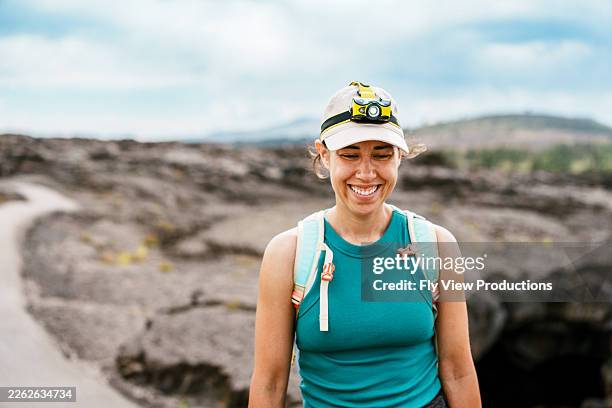 smiling female hiker exploring lava field - idaho stock pictures, royalty-free photos & images
