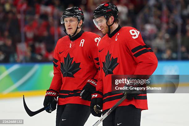 Nathan MacKinnon and Connor McDavid of Team Canada talk while waiting for the video review in the third period during the Men's Semifinals Playoff...