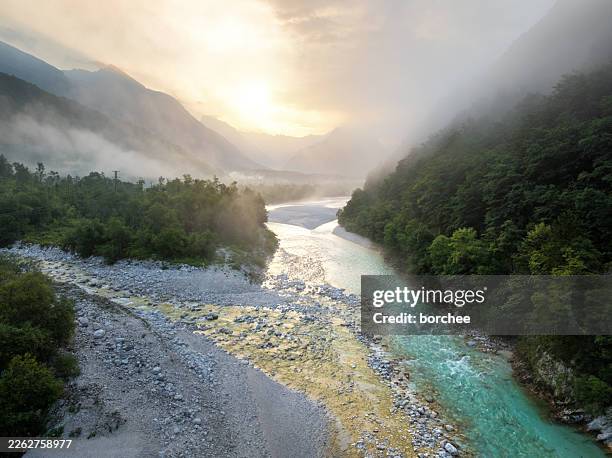 soca river valley at sunrise with mist and golden light - slovenia stock pictures, royalty-free photos & images