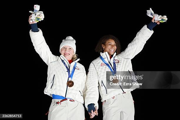 Bronze medalists Kaillie Armbruster Humphries and Jasmine Jones of Team United States celebrate on the podium during the medal ceremony for the...