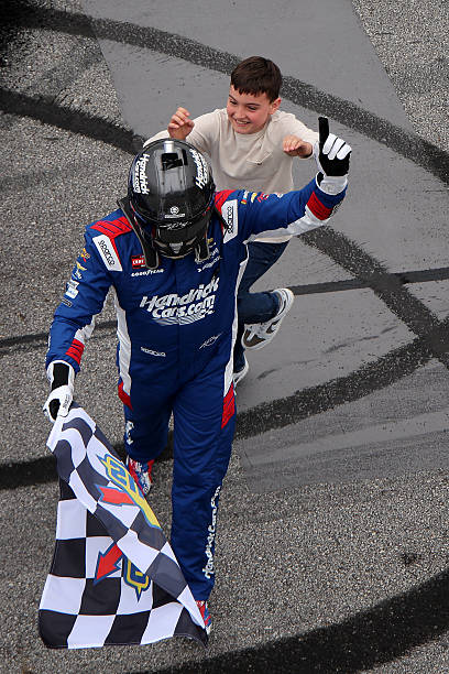 Kyle Busch, driver of the HendrickCars.com Chevrolet, is congratulated by his son, Brexton Busch after winning the NASCAR Craftsman Truck Series Fr8...