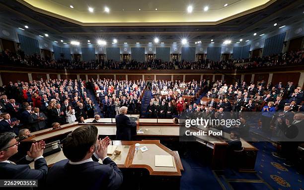Members of Congress give a standing ovation to U.S. President Donald Trump after he delivered the State of the Union address during a joint session...