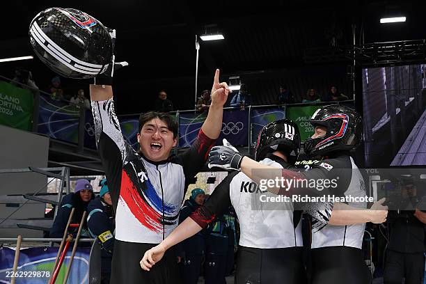 Pilot Jinsu Kim, Hyeonggeun Kim, Geonu Lee and Sunwook Kim of Team Republic of Korea celebrate after competing in the Bobsleigh Four-Man Heat 4 on...