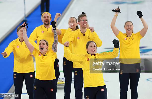 Gold medalists Anna Hasselborg, Sara McManus, Agnes Knochenhauer, Sofia Scharback and Johanna Heldin of Team Sweden celebrate with coaches Kristian...