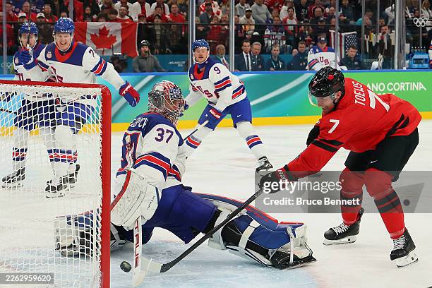 Connor Hellebuyck of Team United States makes a save against Devon Toews of Team Canada in the third period during the Men's Gold Medal match between...