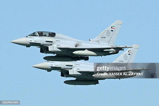 Kuwaiti Air Force Eurofighter Typhoon fighter aircraft fly over during an airshow commemorating Kuwait's 65th Independence Day in Kuwait City on...