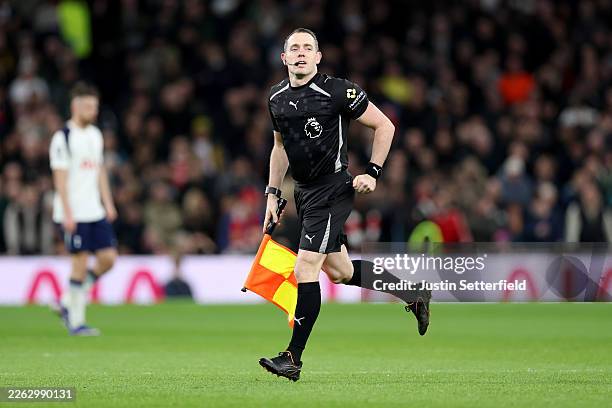 Assistant Referee Edward Smart looks on after technical issues with the match officials' communication devices during the Premier League match...