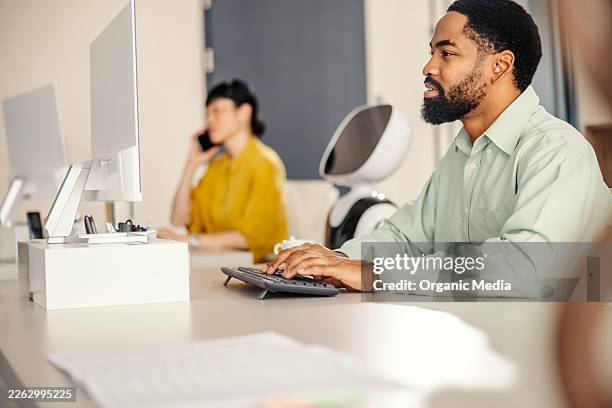 people and robot working in modern office environment - robot keyboard stock pictures, royalty-free photos & images