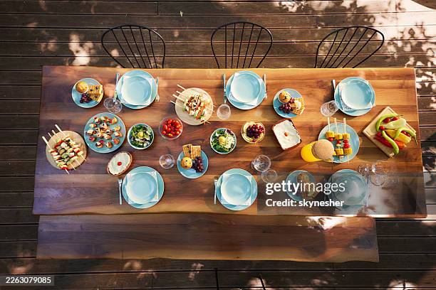 picnic table ready for lunch! - outdoor table setting stock pictures, royalty-free photos & images