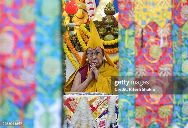 The Tibetan spiritual leader, the 14th Dalai Lama, performs prayers on the official ceremony marking the 86th anniversary of enthronement of His...