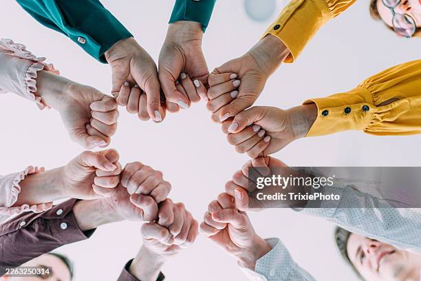 fist bump greeting! - stacked hands stock pictures, royalty-free photos & images