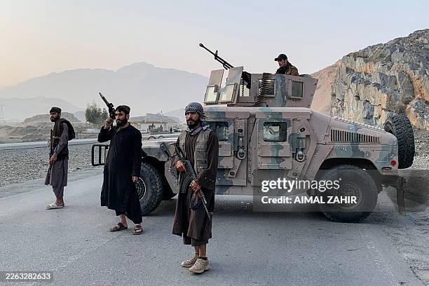 Taliban security personnel stand guard near the Torkham border crossing between Afghanistan and Pakistan in the Nangarhar province on February 27,...