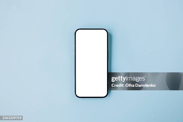 smartphone with blank white screen for copy space on blue background - table top view stock pictures, royalty-free photos & images