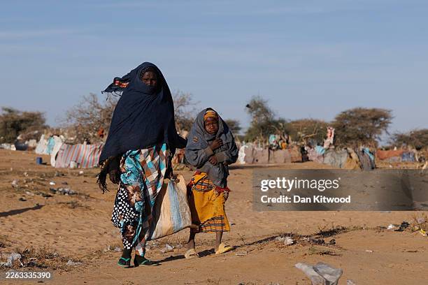 Sudanese refugees walk through the cold morning air at the Oure Cassoni refugee camp on February 24, 2026 in Oure Cassoni, Chad. In April 2023 civil...