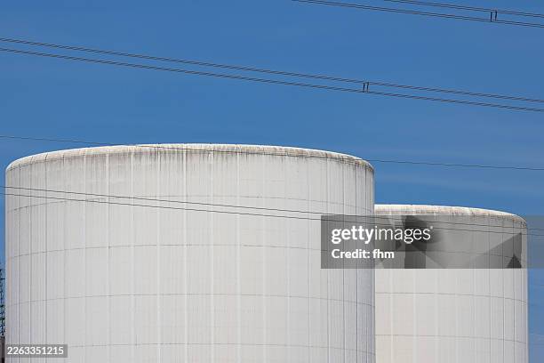 two large white storage tanks for gas with blue sky - fuel storage tank stock pictures, royalty-free photos & images