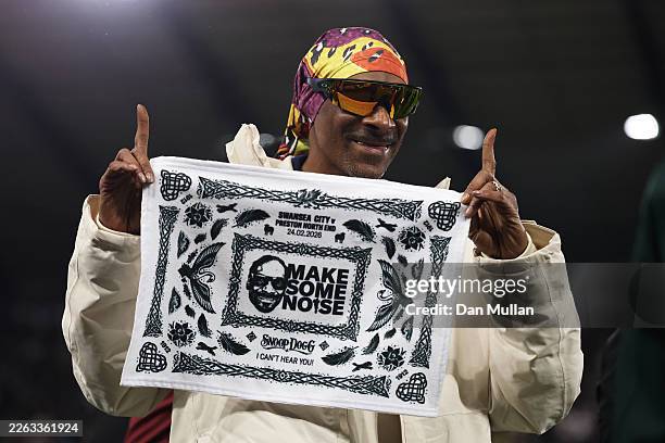 Snoop Dogg, rapper and co-owner of Swansea City poses for a photo with merchandise prior to the Sky Bet Championship match between Swansea City and...