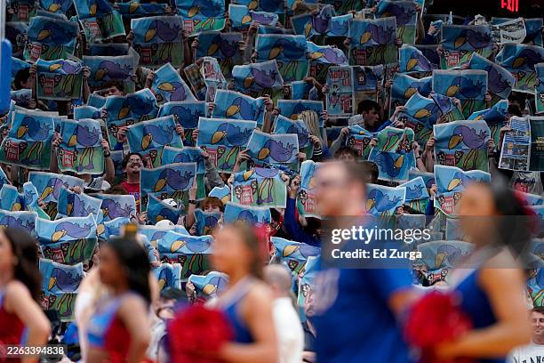Kansas fans wave newspapers as they cheer for their team prior to a game against the Houston Cougars at Allen Fieldhouse on February 23, 2026 in...
