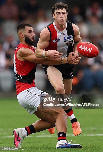 Darcy Wilson of the Saints is tackled by Saad El-Hawli of the Bombers during the 2026 AFL AAMI Community Series match between the St Kilda Saints and...