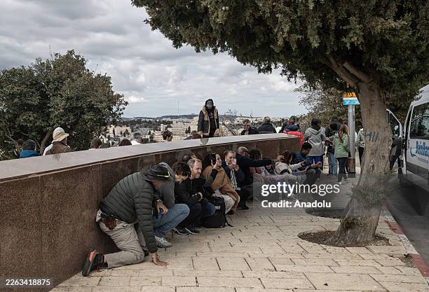 People take shelter as Iran launched missiles and drones towards Israel following the US-Israeli attacks, in Jerusalem on February 28, 2026. Israeli...