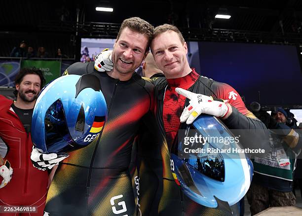 Pilot Johannes Lochner of Team Germany is congratulated by Pilot Francesco Friedrich of Team Germany after winning the gold medals after competing in...