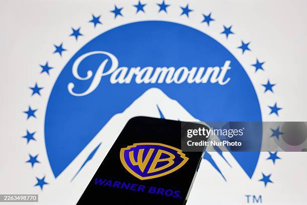 Paramount logo displayed on a laptop screen and Warner Bros logo displayed on a phone screen are seen in this illustration photo taken in Krakow,...