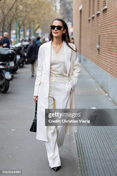 Gabrielle Caunesil Pozzoli wears white coat, pants, shirt, black bag outside Fendi during the Milan Fashion Week - Womenswear Fall/Winter 2026/2027...