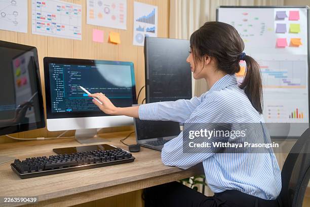 female programmer coding ai software in modern office - writing code stock pictures, royalty-free photos & images