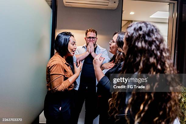 worried young businesswoman receiving support from coworkers in the office - disappointment stock pictures, royalty-free photos & images