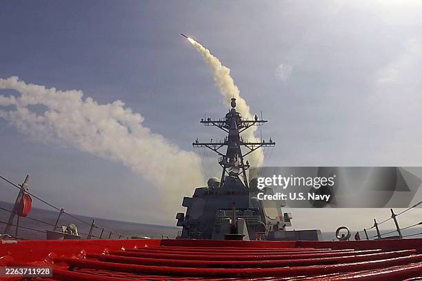 In this U.S. Navy released handout, Arleigh Burke-class guided-missile destroyer USS Frank E. Petersen Jr. Fires a Tomahawk Land Attack Missile...