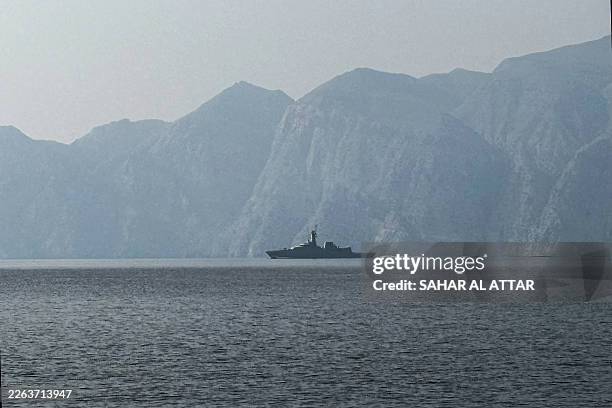 Navy vessel is seen sailing in the Strait of Hormuz, a vital waterway through which much of the world's oil and gas passes on March 1, 2026. Two...