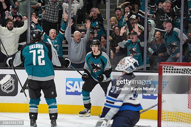 Michael Misa of the San Jose Sharks celebrates scoring the game-winning goal in overtime against the Winnipeg Jets at SAP Center on March 1, 2026 in...