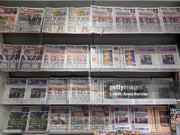 Multiple British newspapers are displayed showing a front-page image and accompanying story about the arrest of Peter Mandelson on suspicion of...