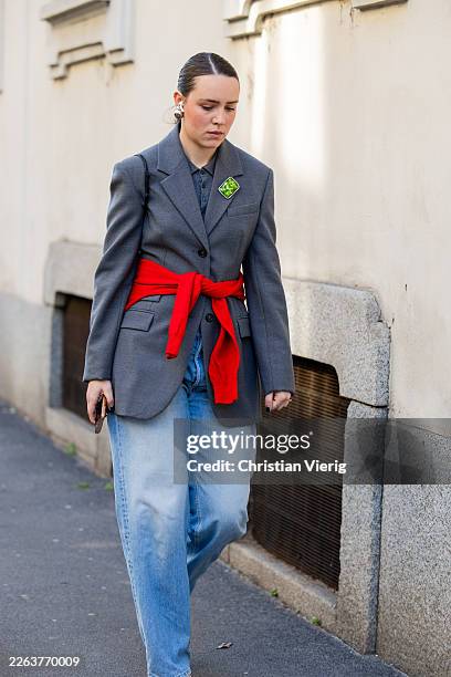 Guest wears grey blazer, light washed denim jeans outside Anteprima during the Milan Fashion Week - Womenswear Fall/Winter 2026/2027 on February 26,...