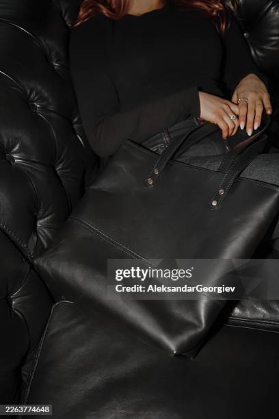 elegant female in modern interior with luxury handbag - monochrome clothing stock pictures, royalty-free photos & images