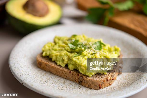 vegan mashed avocado toast - limes plate no people stock pictures, royalty-free photos & images