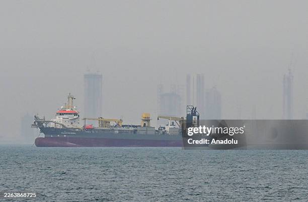 Commercial ship is viewed anchored off the coast of the United Arab Emirates, in the Strait of Hormuz, Dubai on March 2, 2026. Increased maritime...