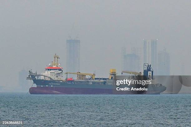 Commercial ship is viewed anchored off the coast of the United Arab Emirates, in the Strait of Hormuz, Dubai on March 2, 2026. Increased maritime...