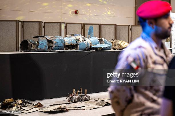 Pieces of missiles and drones recovered after Iran's strikes are displayed during a press briefing by the UAE government held in Abu Dhabi on March...