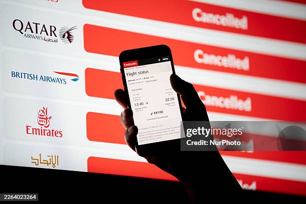 The status of a cancelled Emirates flight is displayed on a mobile phone screen, and a website with flight cancellations is seen on a computer screen...