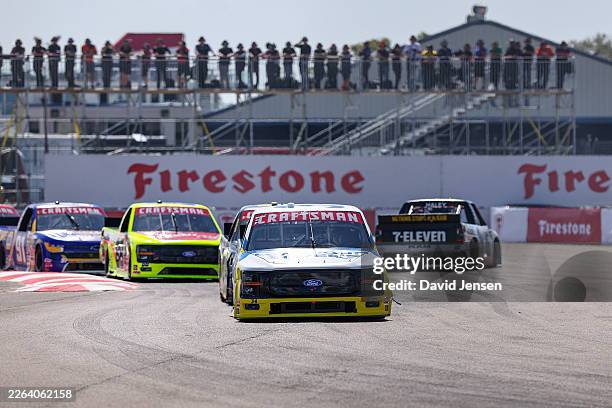 Layne Riggs, driver of the Long John Silver's Ford, drives as Justin Haley, driver of the Celsius RAM, spins after an on-track incident during the...