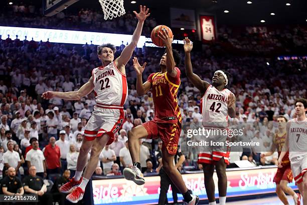 Arizona Wildcats guard Addison Arnold attempts to block a shot by Iowa State Cyclones guard Dominick Nelson during a men's basketball game between...