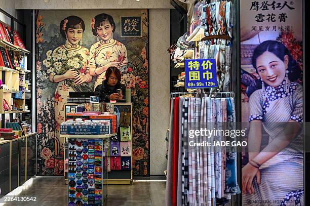Vendor waits for customers at a souvenir shop on the Nanjing Road Pedestrian Street in Shanghai on March 4, 2026.