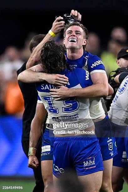 Lachlan Galvin and Jaeman Salmon of the Bulldogs celebrate victory during the round one NRL match between Canterbury Bulldogs and St George Illawarra...